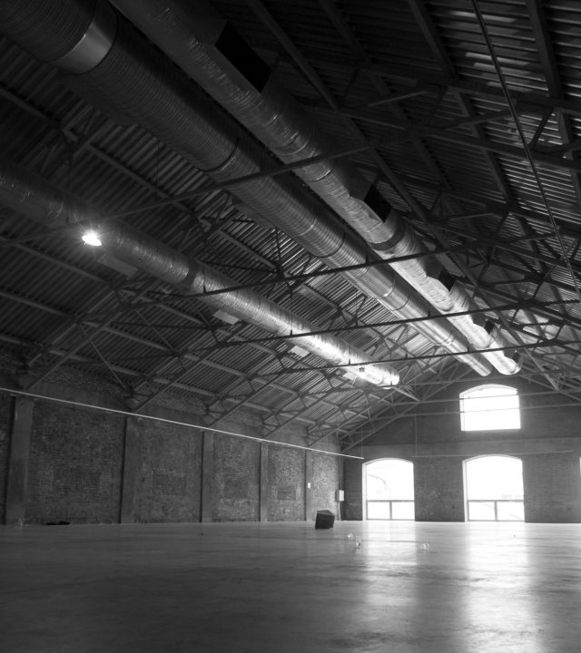 Large empty hangar with light going through the windows